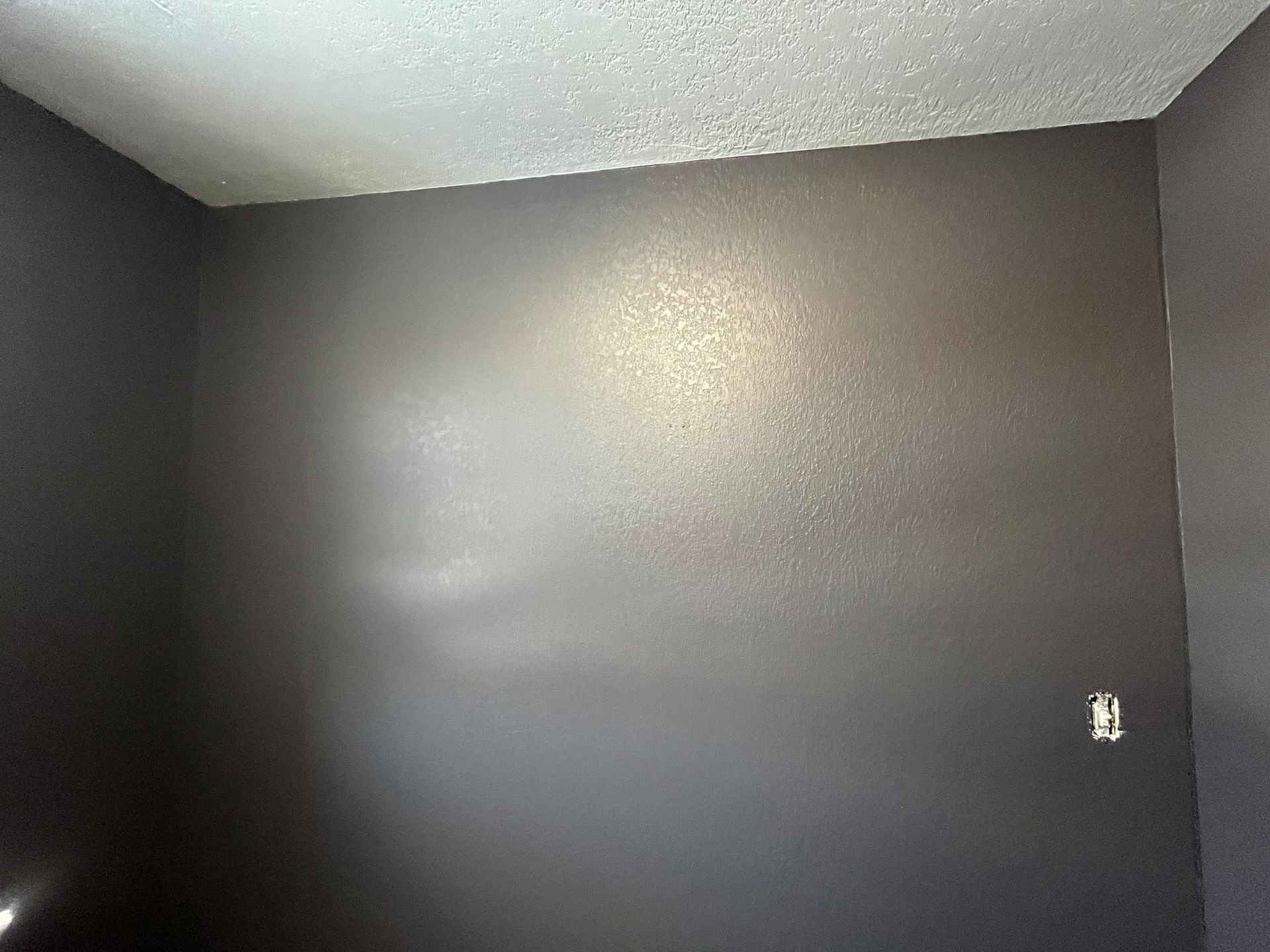 A room with gray walls and a white ceiling.