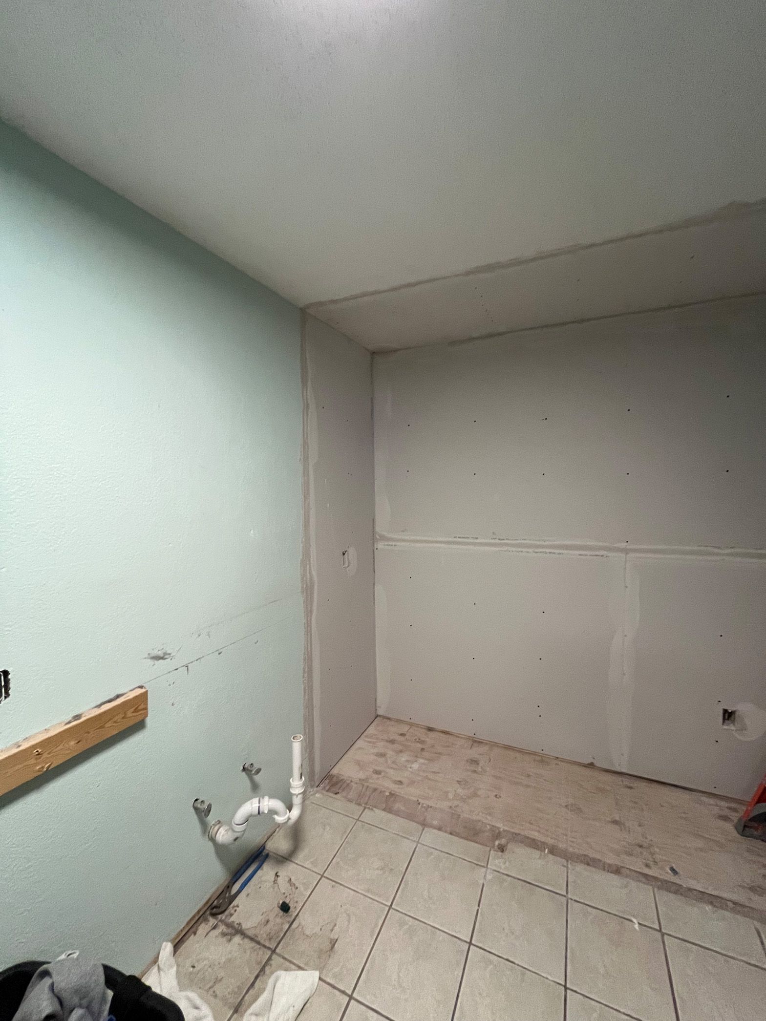 A room with tile floors and a ceiling that is being remodeled.