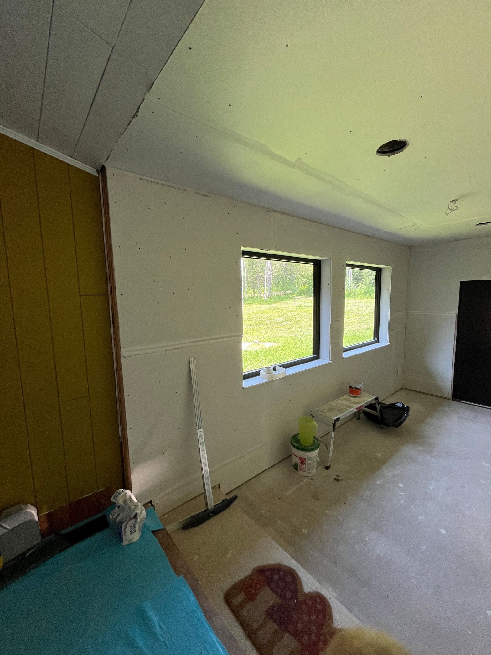 A room with a lot of windows and a couch in it.