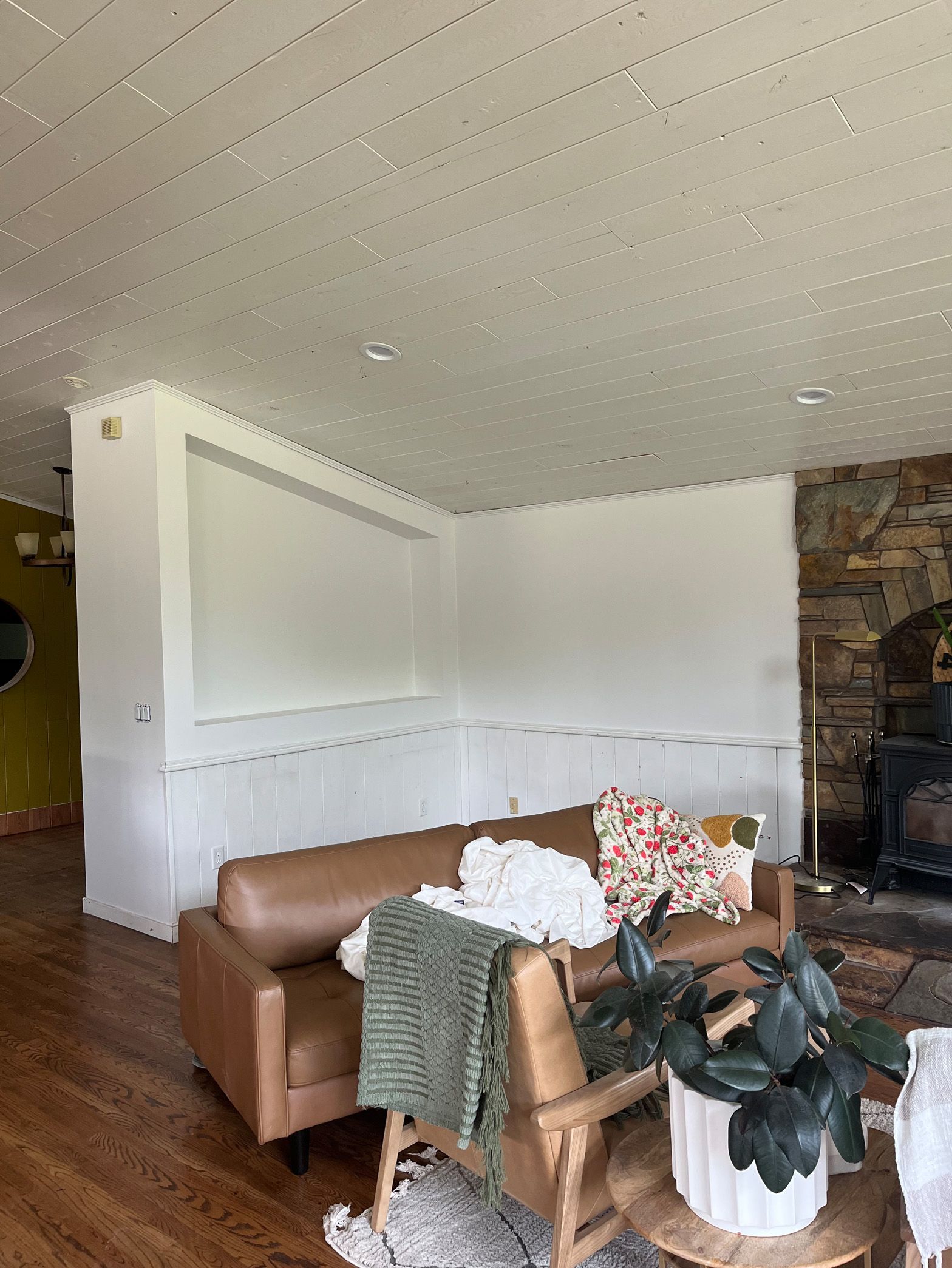 A living room with a couch , chair , and fireplace.