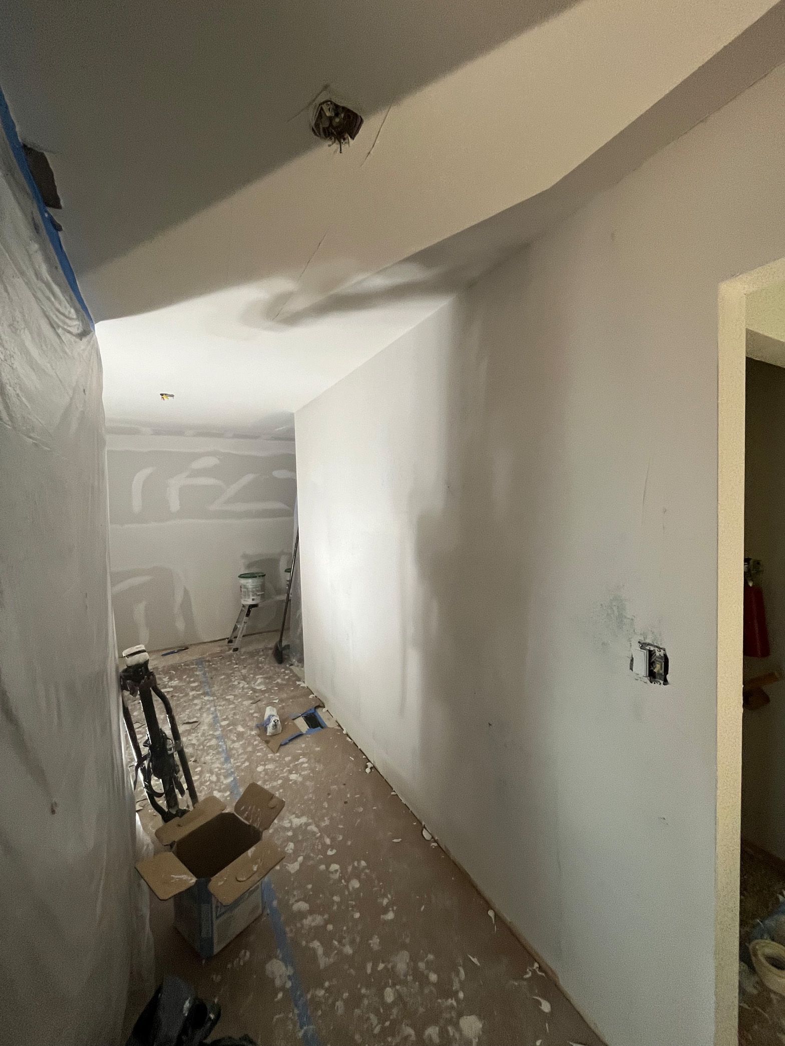 A room with white walls and a box on the floor.