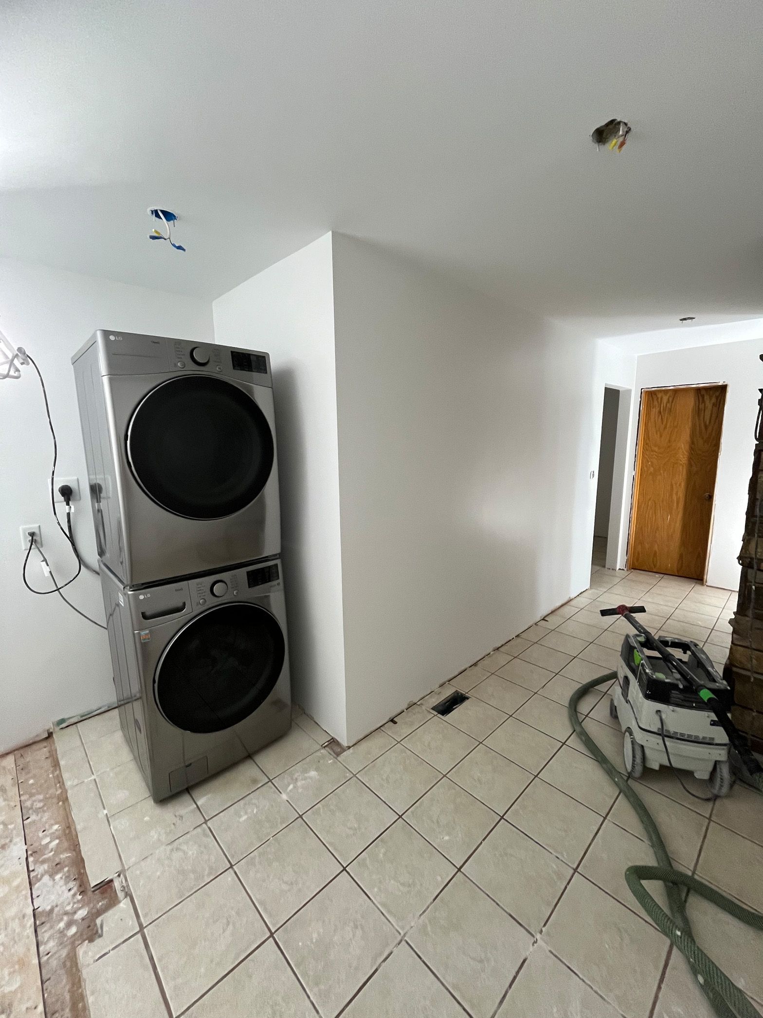 A washer and dryer are stacked on top of each other in a room.