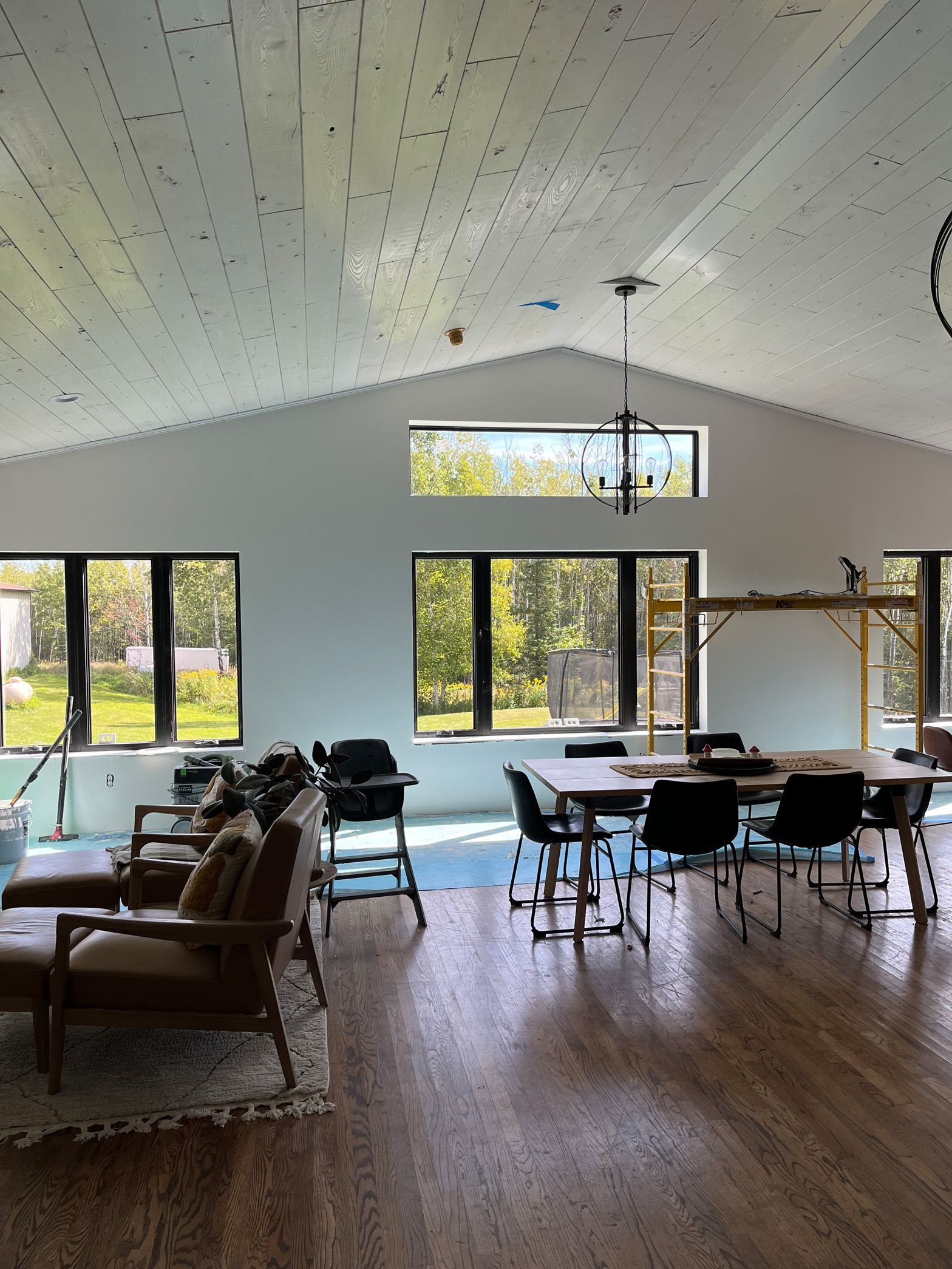 A large room with a lot of windows and tables and chairs