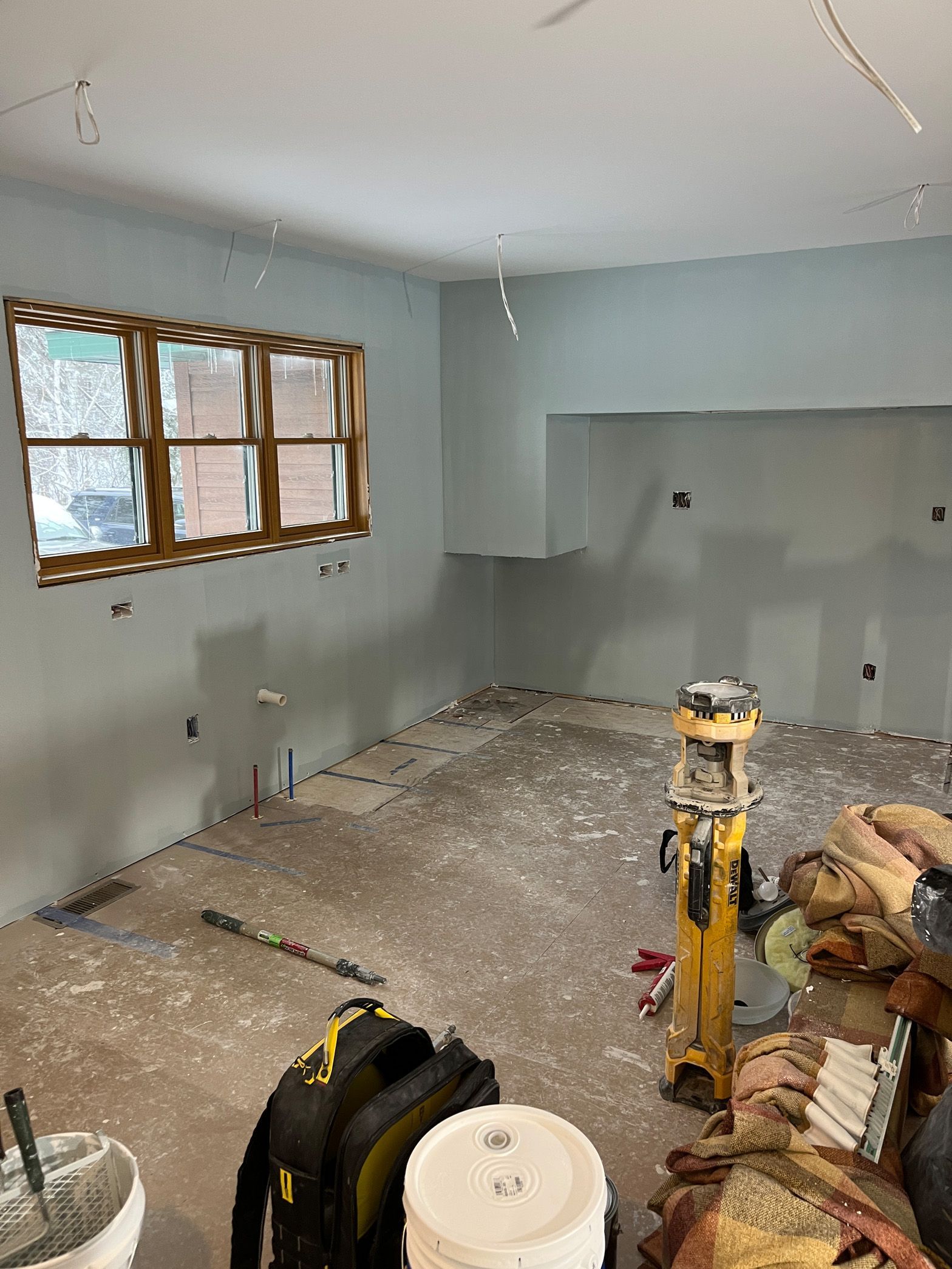 A room that is being remodeled with a lot of tools on the floor.