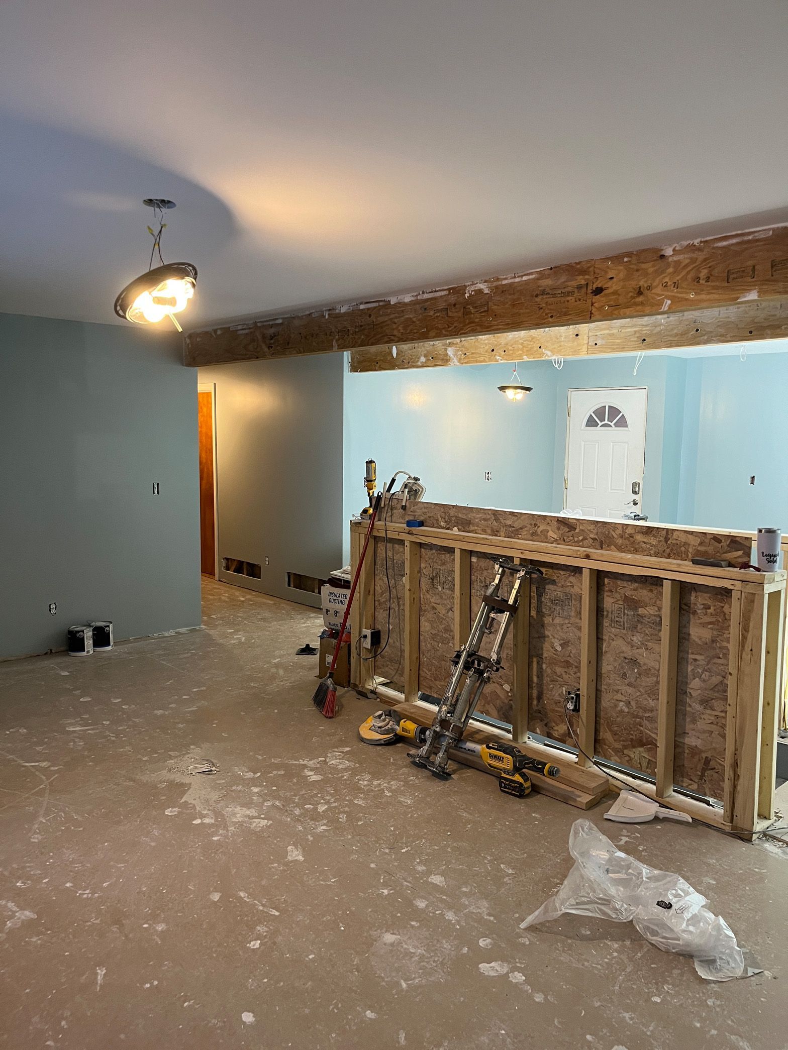 An empty room with a ladder in the middle of it