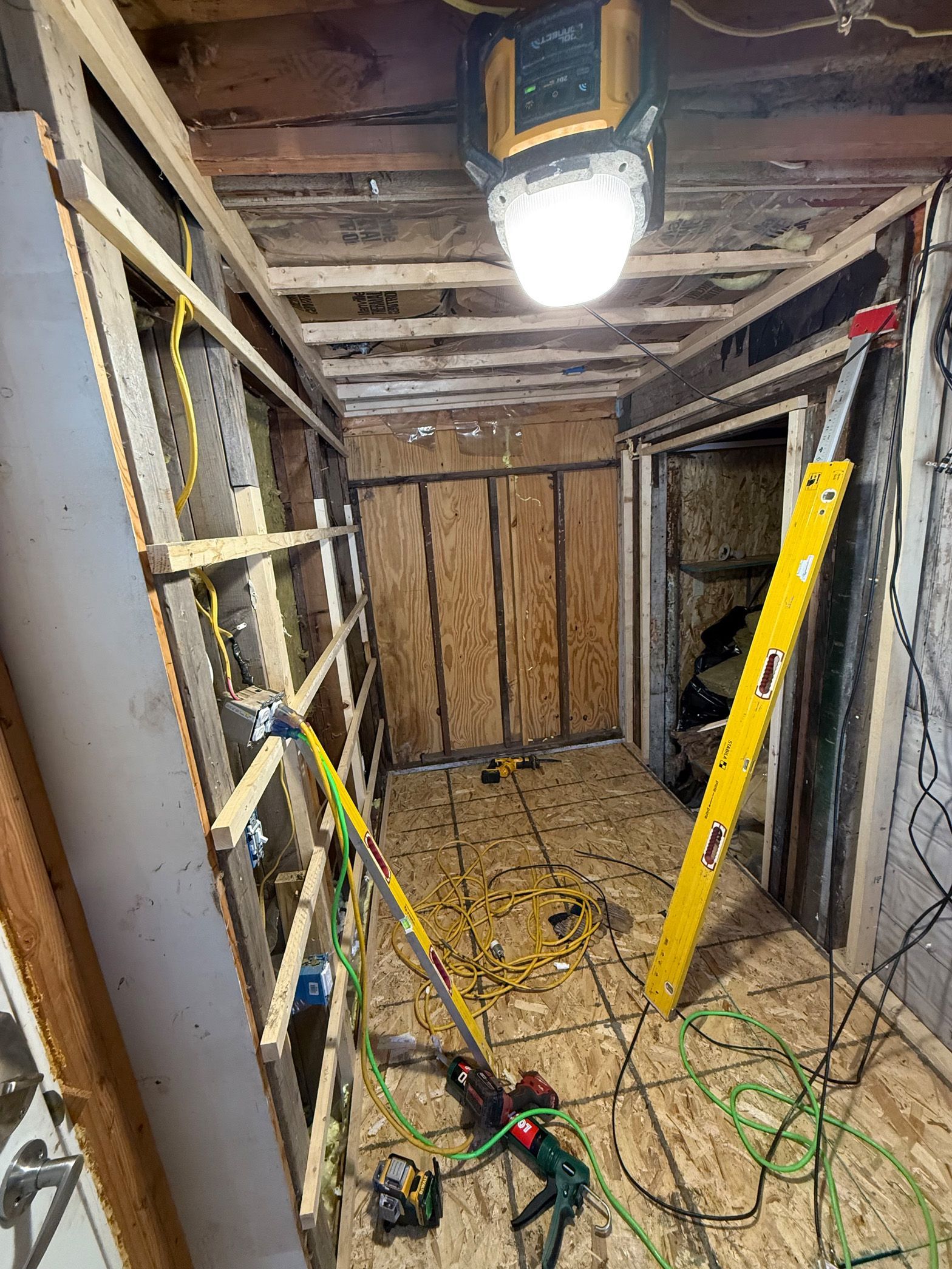 A room with a lot of tools and a light on the ceiling.