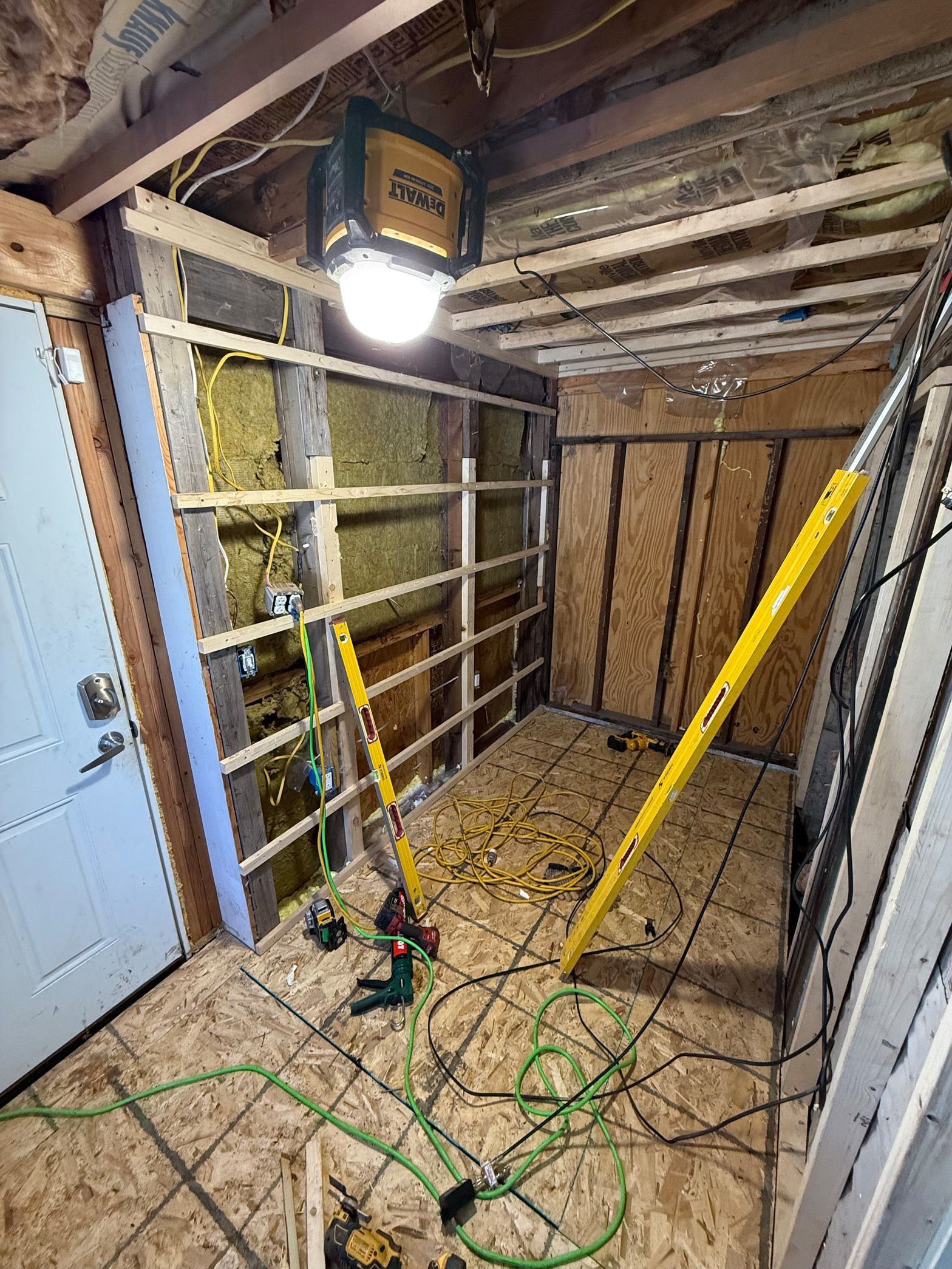 A room with a lot of electrical wires hanging from the ceiling.