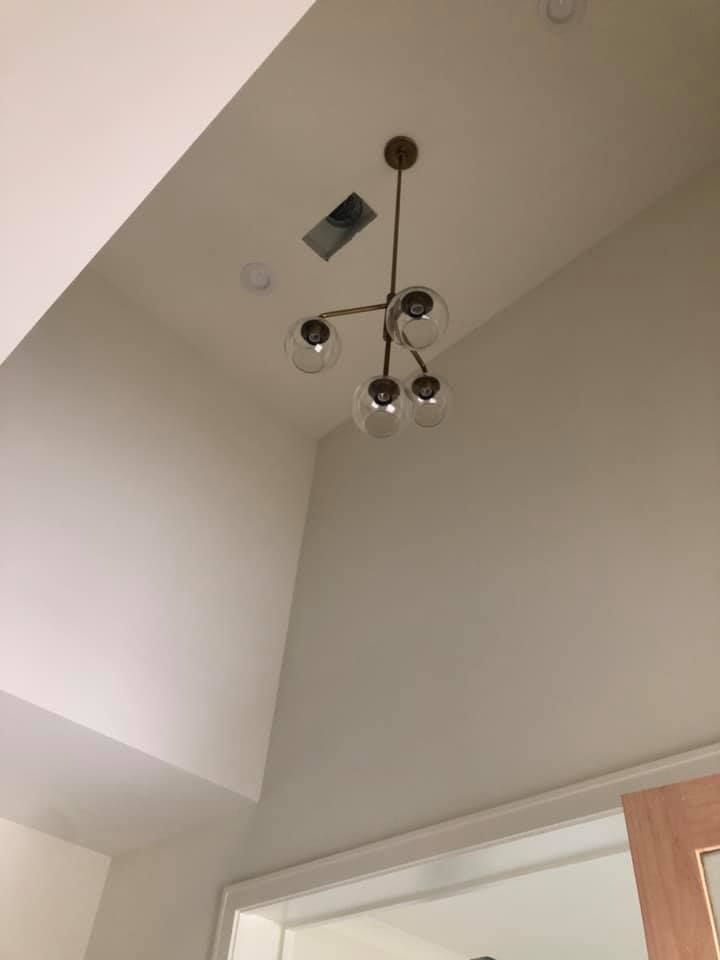 A chandelier is hanging from the ceiling of a room.