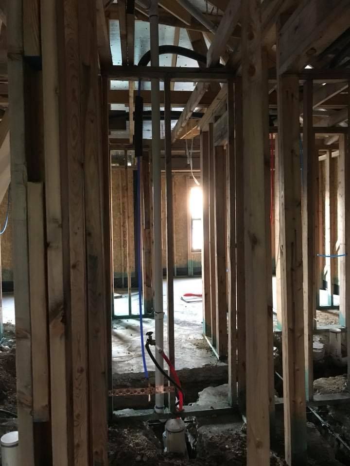 A building under construction with a lot of pipes