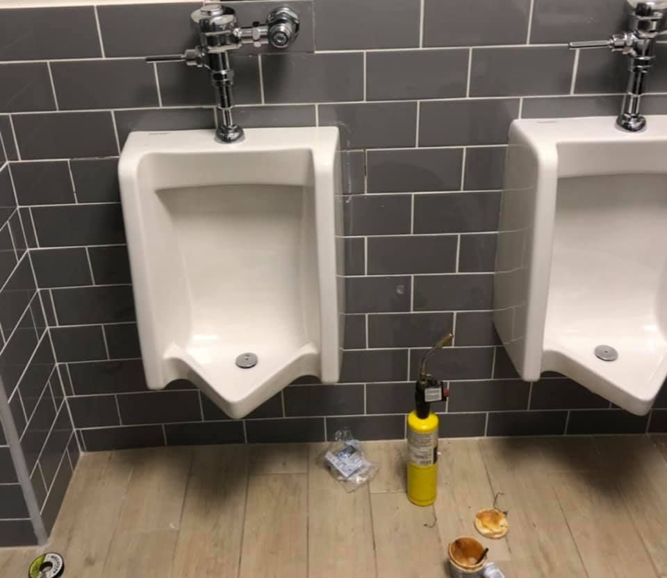 Two urinals next to each other in a bathroom