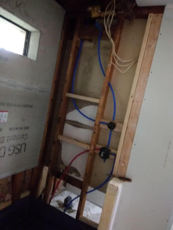 A bathroom with a ladder and a water tank