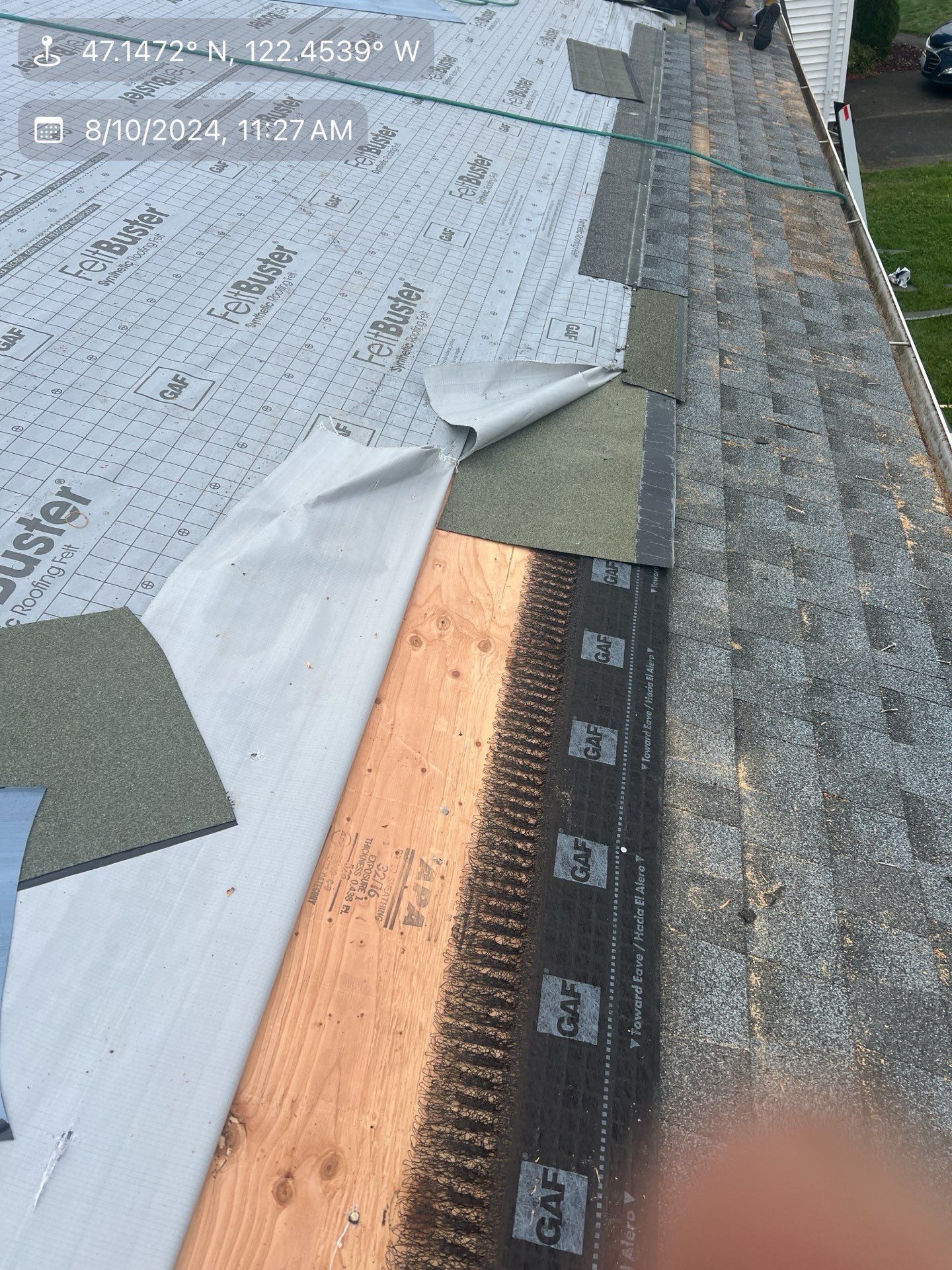 Roof partially covered with asphalt shingles, underlayment, and exposed wood.