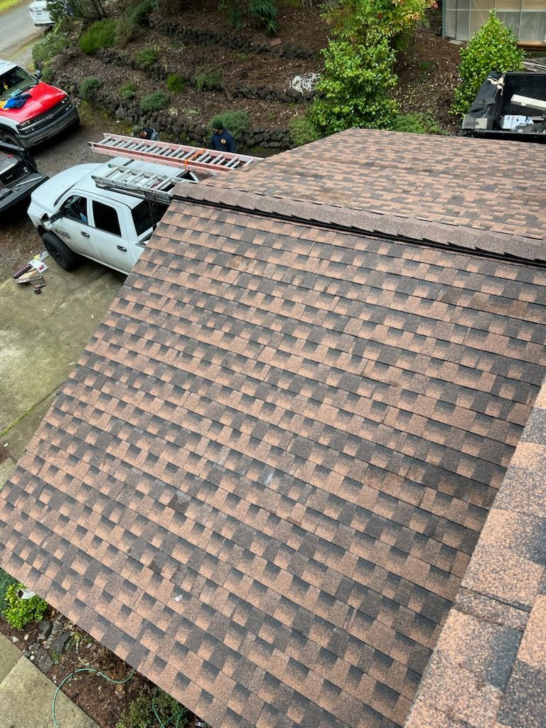 Damaged asphalt shingles before repair by Team Roofing NW in Kent, WA.
