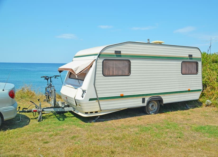 White Camper Trailer Parked on Grass Near the Ocean — BCV Storage Centre in Wauchope, NSW