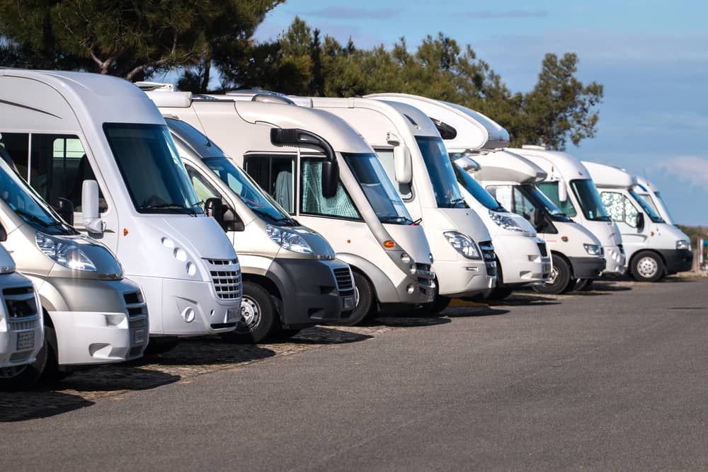 Row of white RVs Parked on Asphalt, Under a Blue Sky, Possibly at a Campground — BCV Storage Centre in Laurieton, NSW