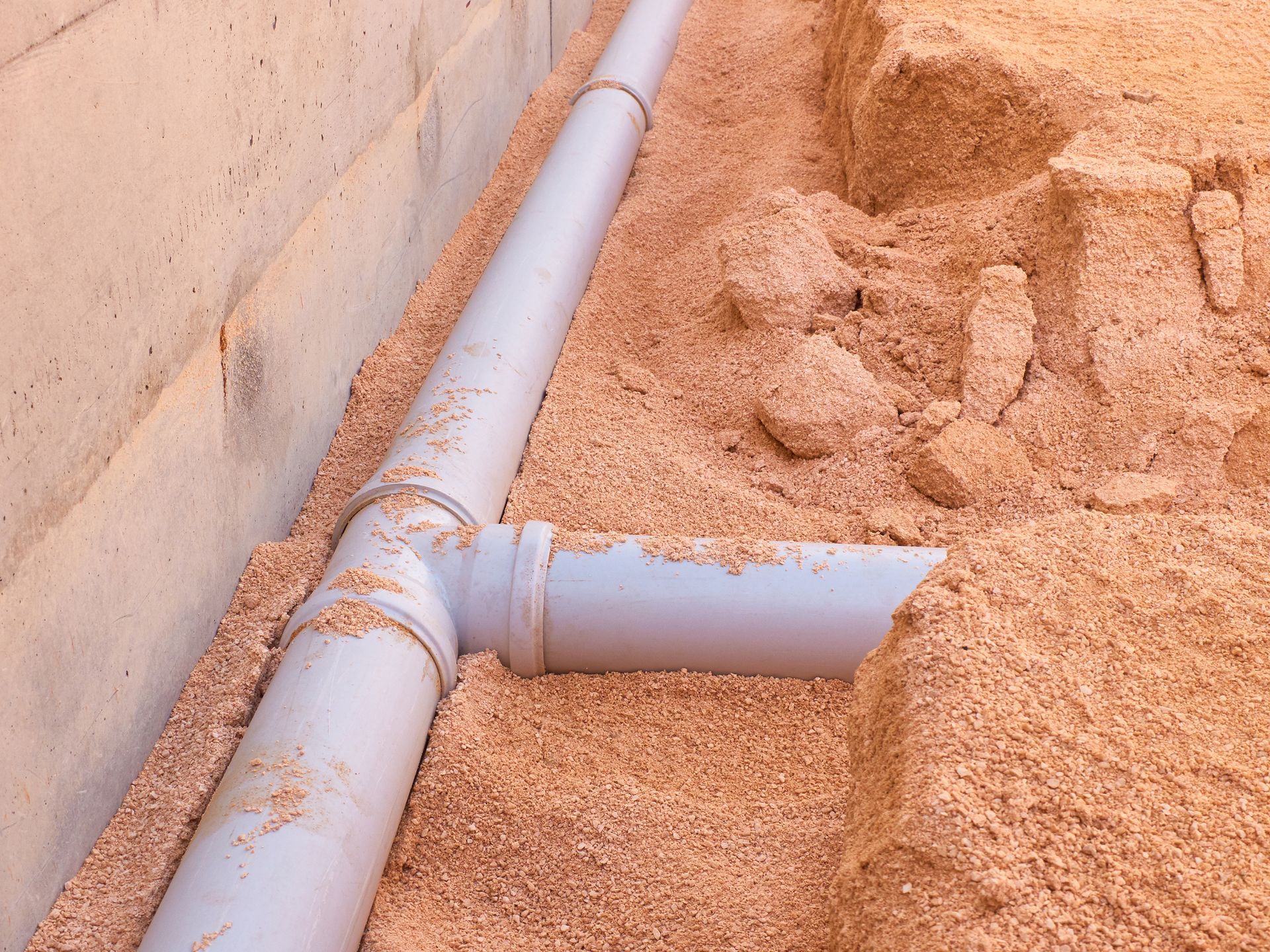 PVC Sewer line of a home in the middle of construction, on the loose ground.