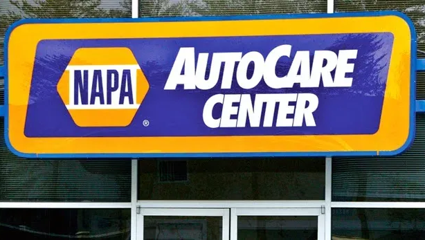 NAPA AutoCare Center sign with blue, yellow, and white text above glass doors.