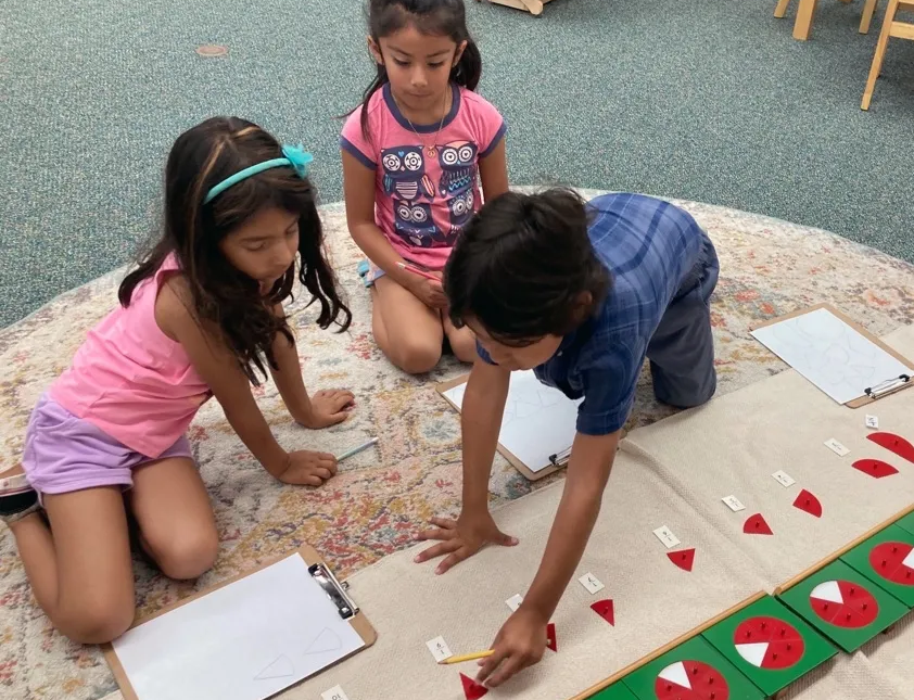 Montessori children working with math materials 