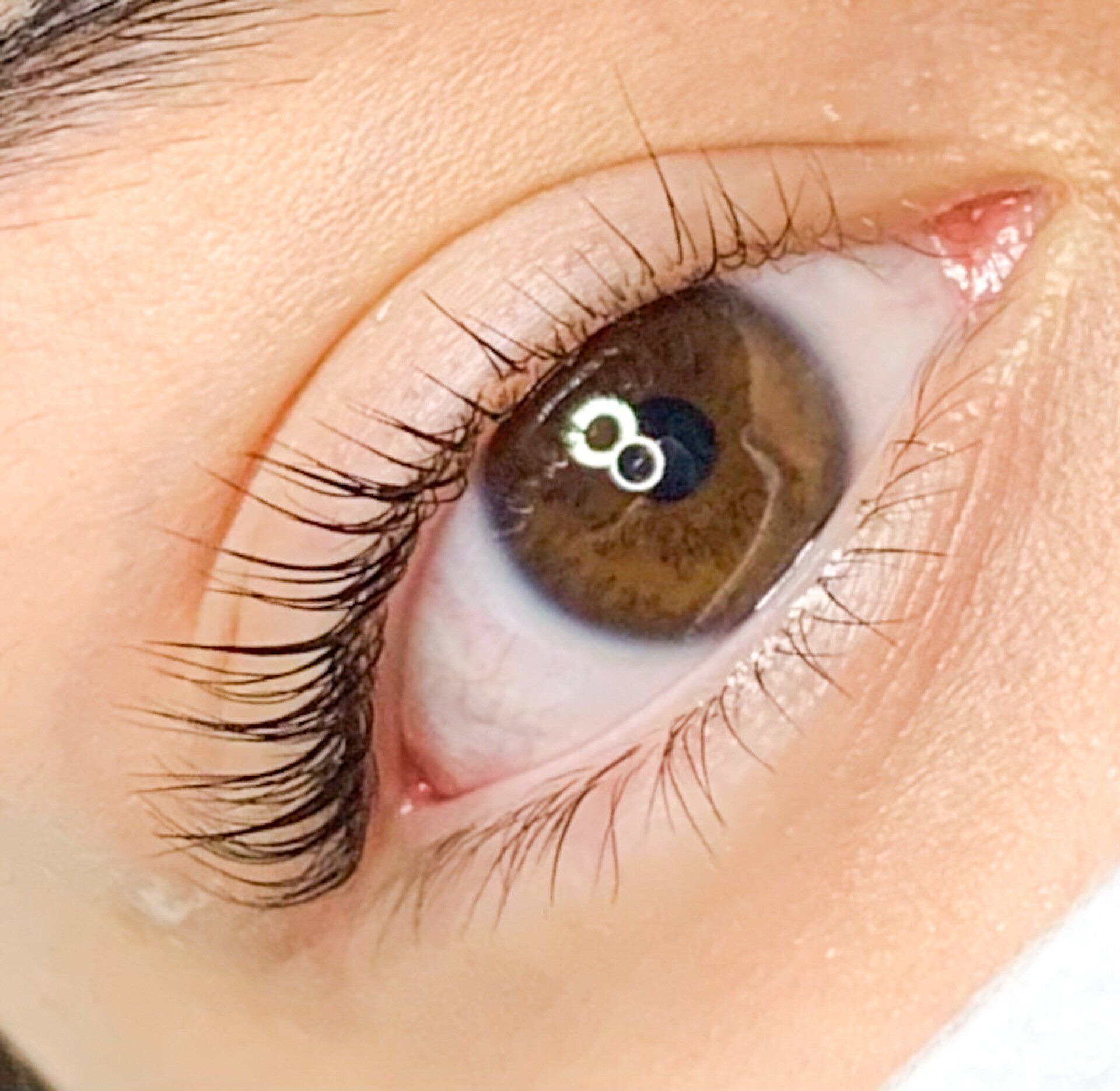 A close up of a woman 's eye with the number 8 on it