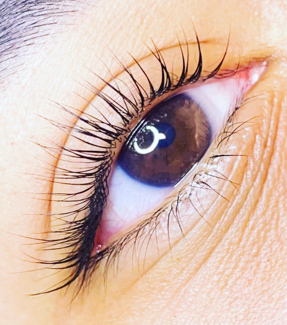A close up of a woman 's eye with long eyelashes