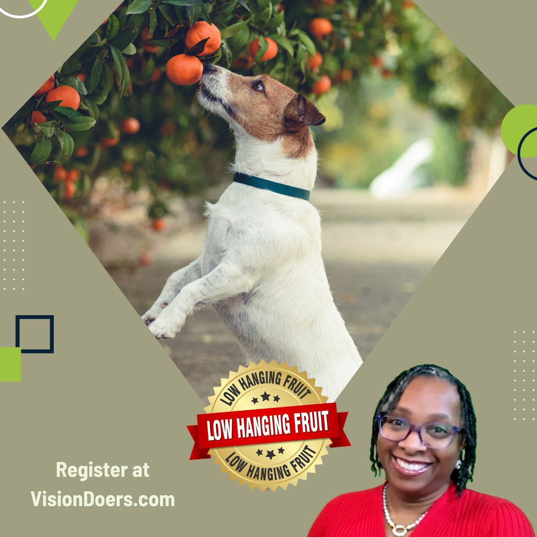 A dog is reaching for an orange from a tree