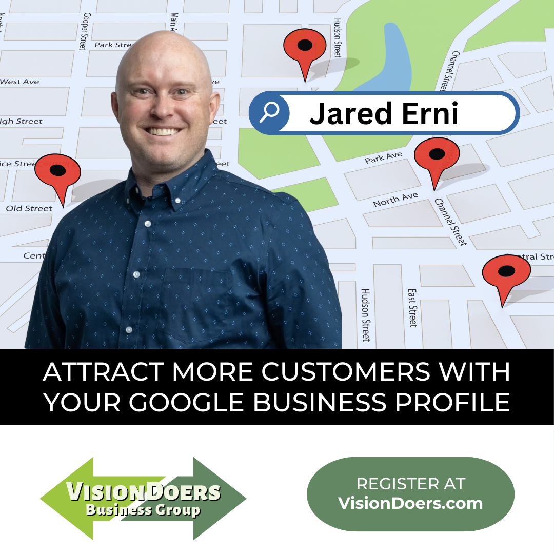 A man in a blue shirt is standing in front of a map.