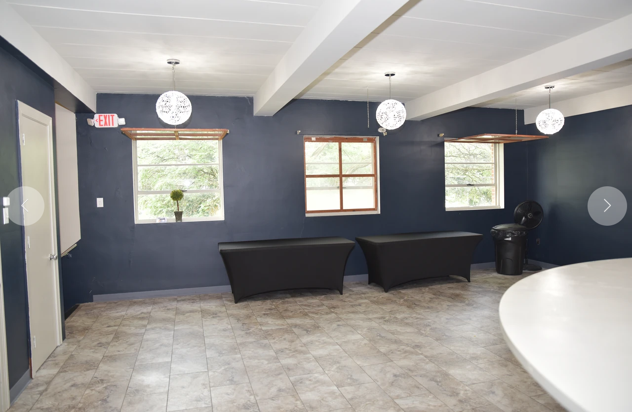 An empty room with blue walls and a white table
