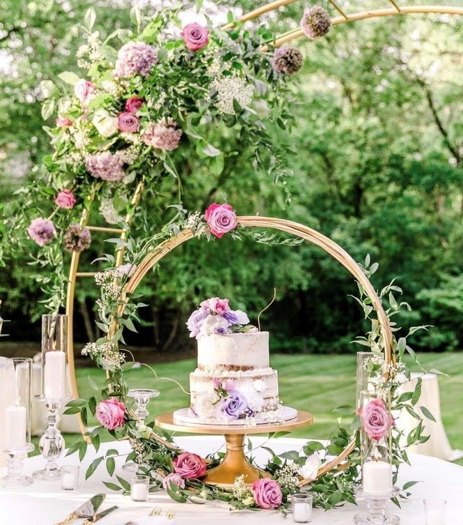 A wedding cake is sitting on top of a table decorated with flowers.