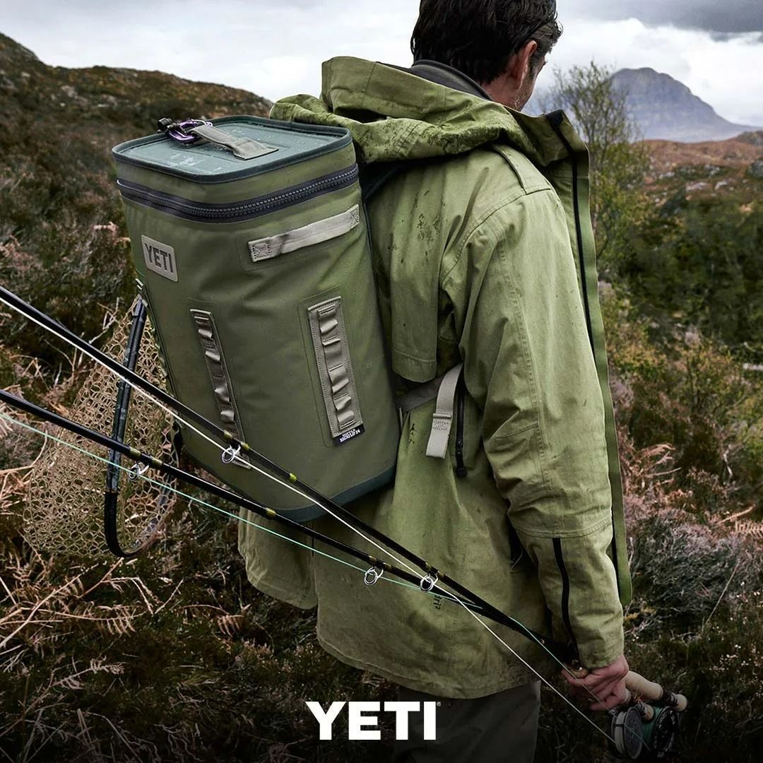Man in Green Jacket Hiking With a Green Yeti Backpack — True Blue Camping Warehouse in North Mackay, QLD