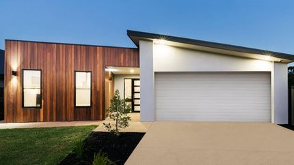 Stunning new windows and doors on a modern, contemporary house.  The windows are single hung windows and are black in colour.  The new entry way has a front door with windows.  The front door also has a modern, contemporary look.