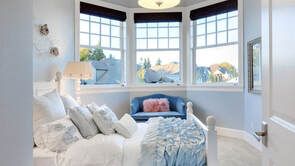 Picture of bay windows in Belleville Ontario.  The windows are white in a child's bedroom.