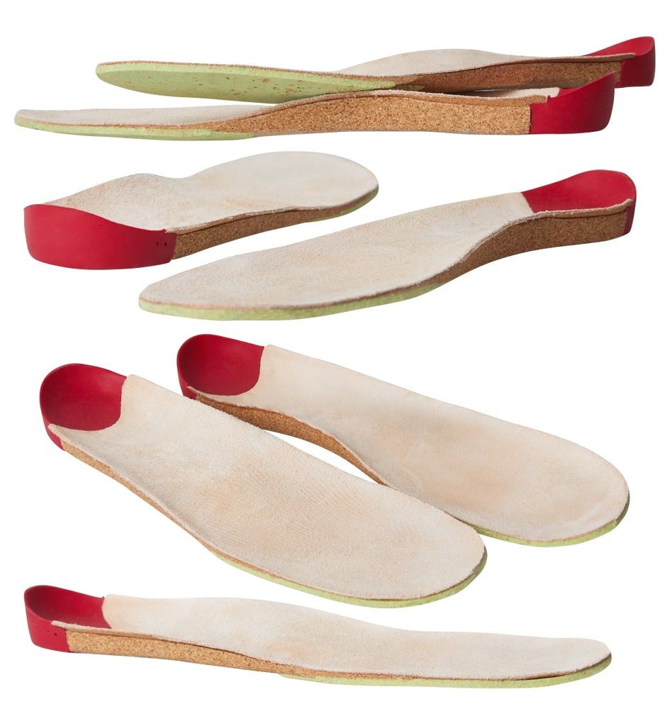 A Bunch of Different Types of Insoles on a White Background — Craig Hughes Podiatry in Mount Hutton, NSW