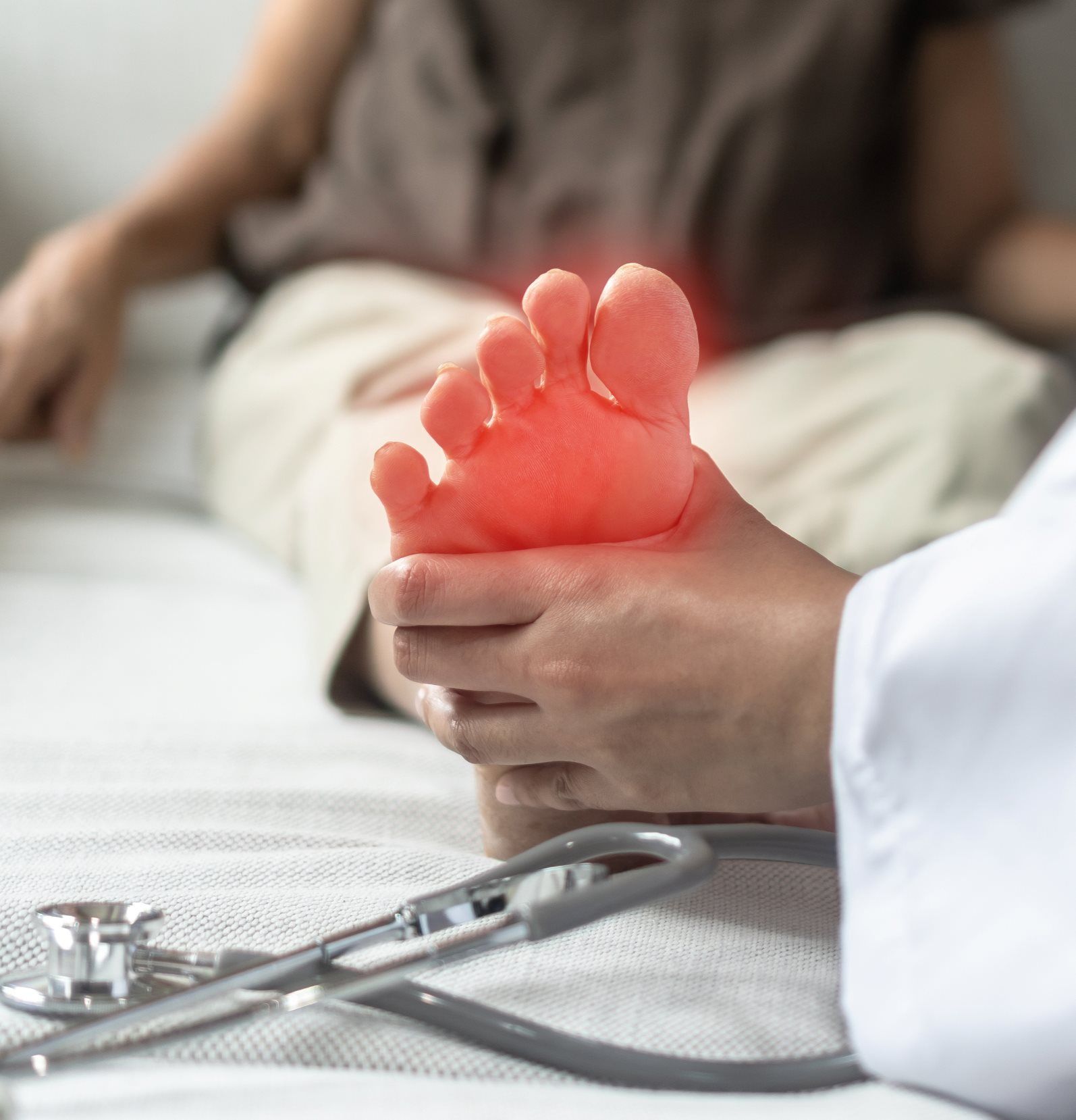 A Doctor is Examining a Patient's Foot With a Stethoscope — Craig Hughes Podiatry in Mount Hutton, NSW