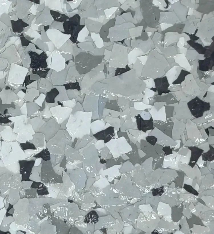 Gray and white speckled terrazzo-like surface with scattered dark chips