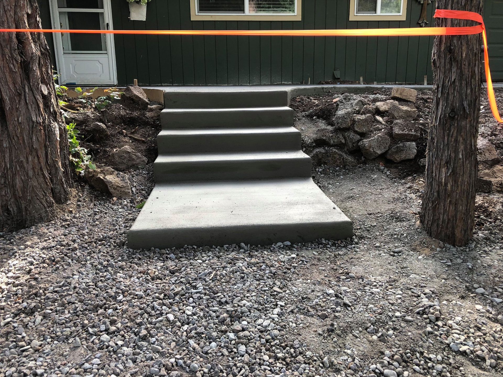 A concrete staircase is being built in front of a house.