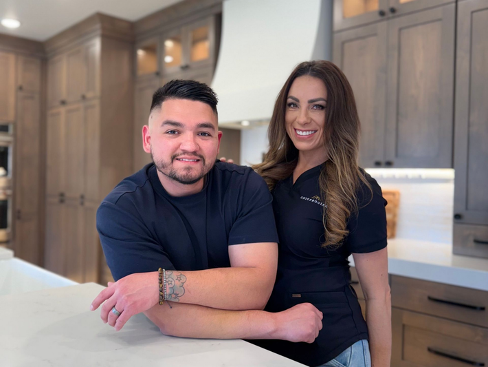 Business owners standing in front of brick wall