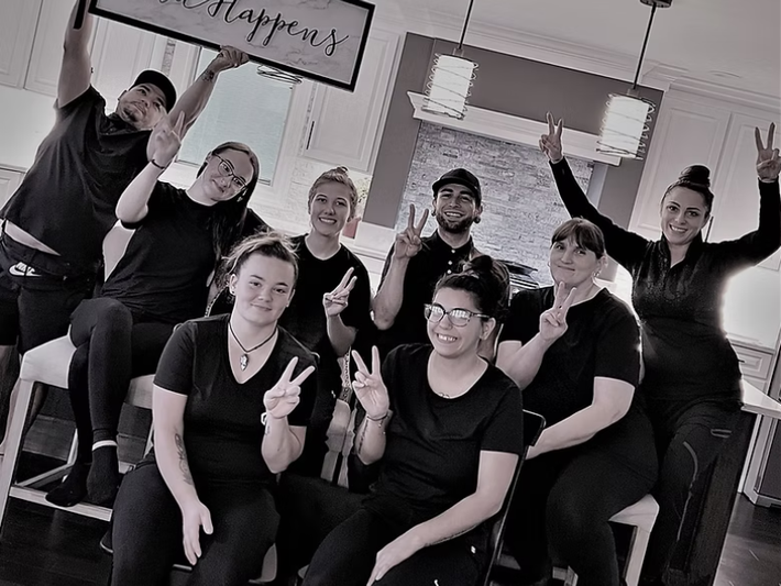 A group of people in black shirts are posing for a picture.