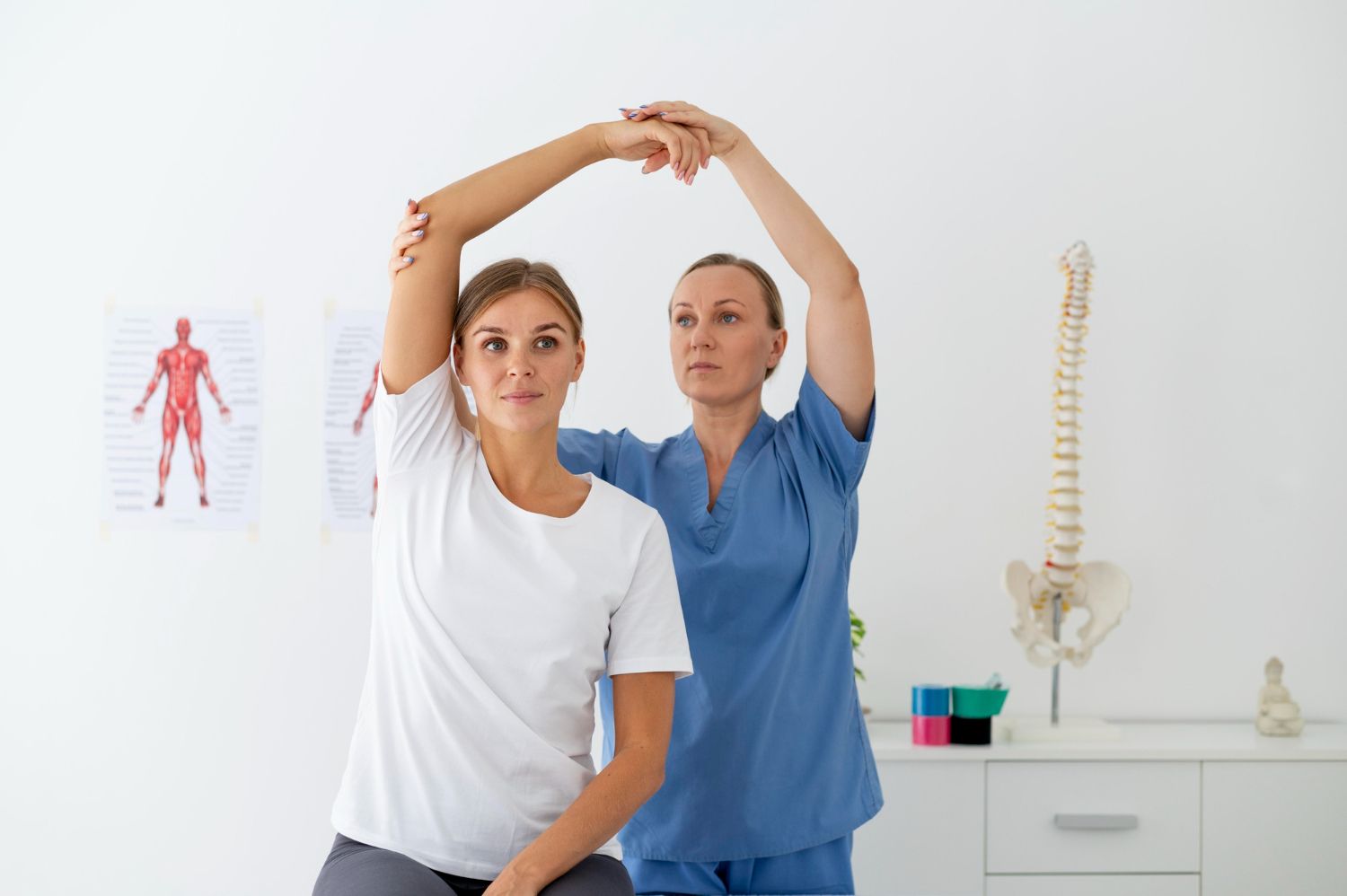 A nurse is helping a patient stretch her arms.