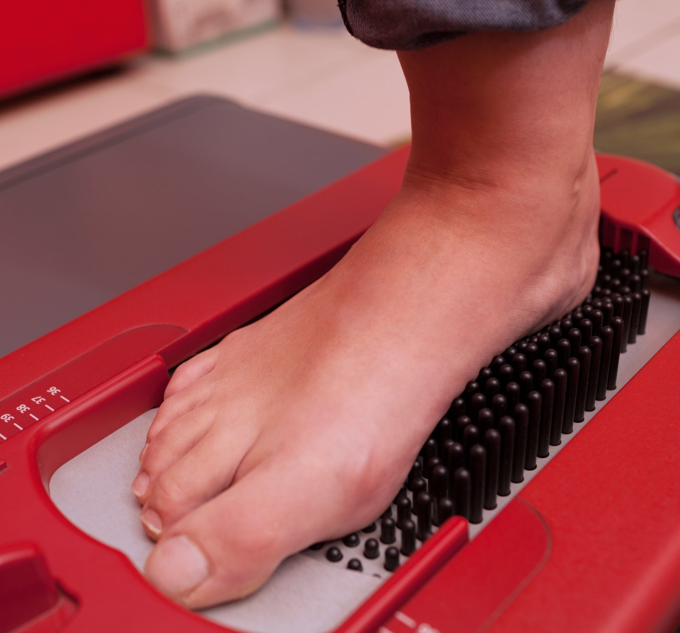 A foot being scanned on a device for orthotics