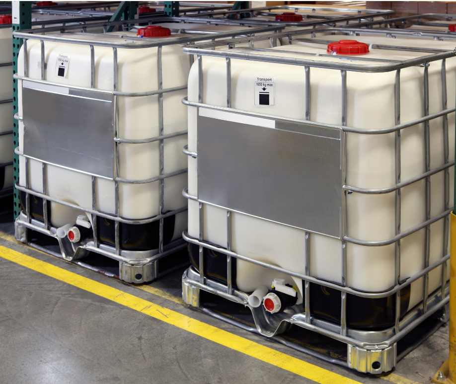 A row of white containers are lined up in a warehouse