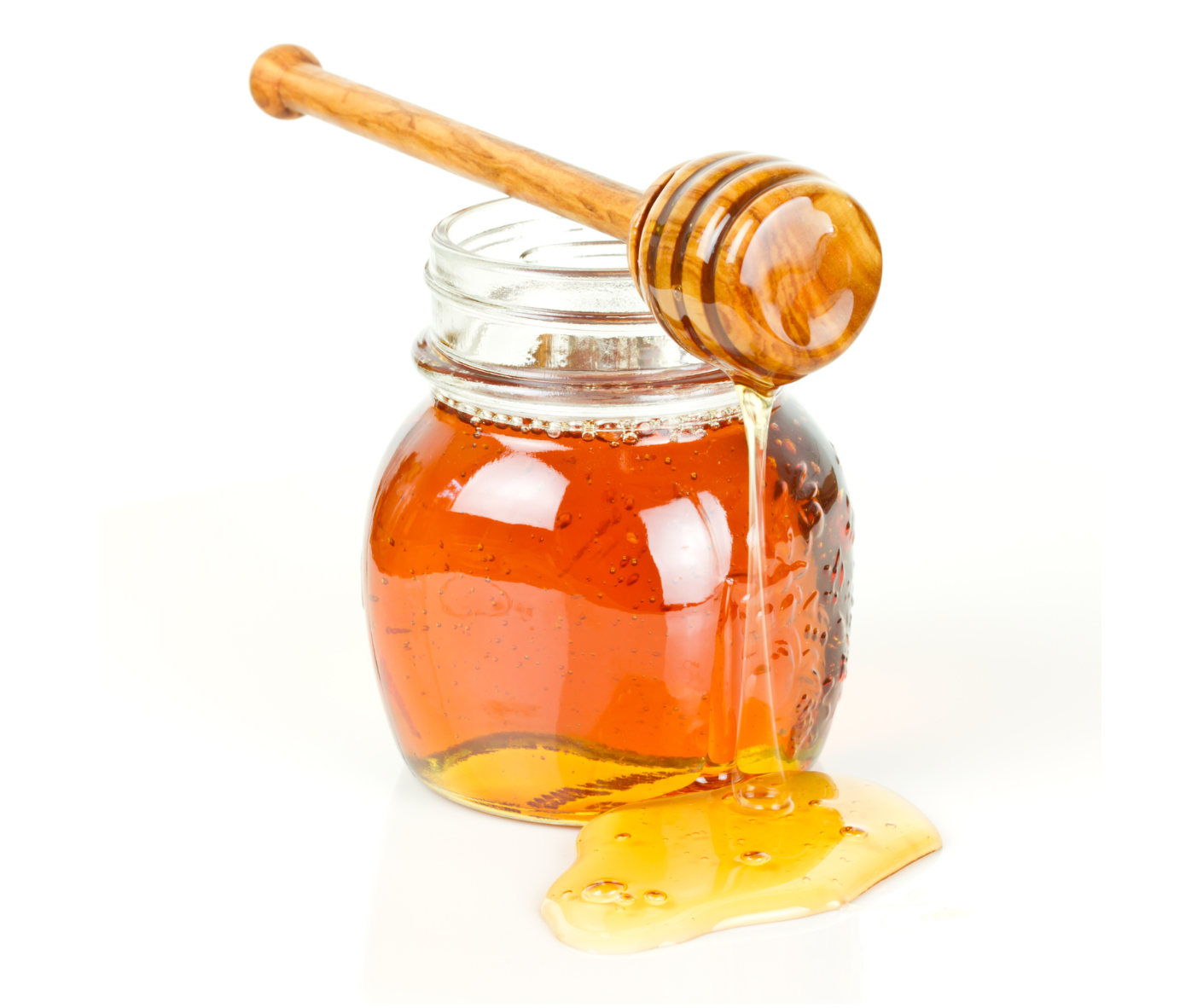 A jar of honey with a honey dipper sticking out of it