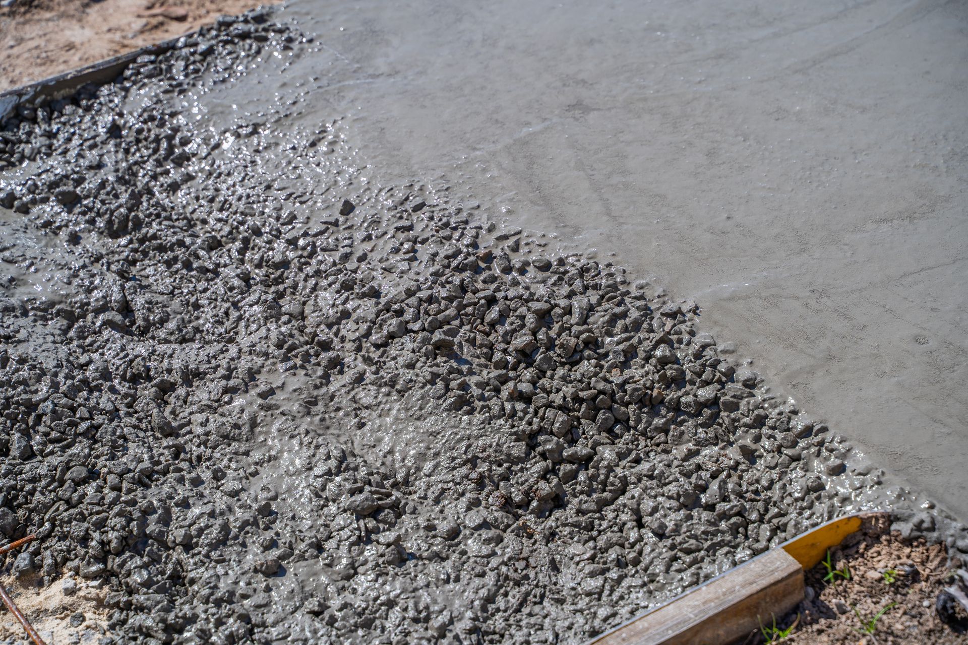 The process of pouring concrete on a path, close-up.