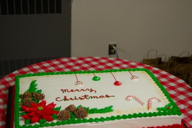 Christmas cake decorated with green and red frosting, ornaments, and 