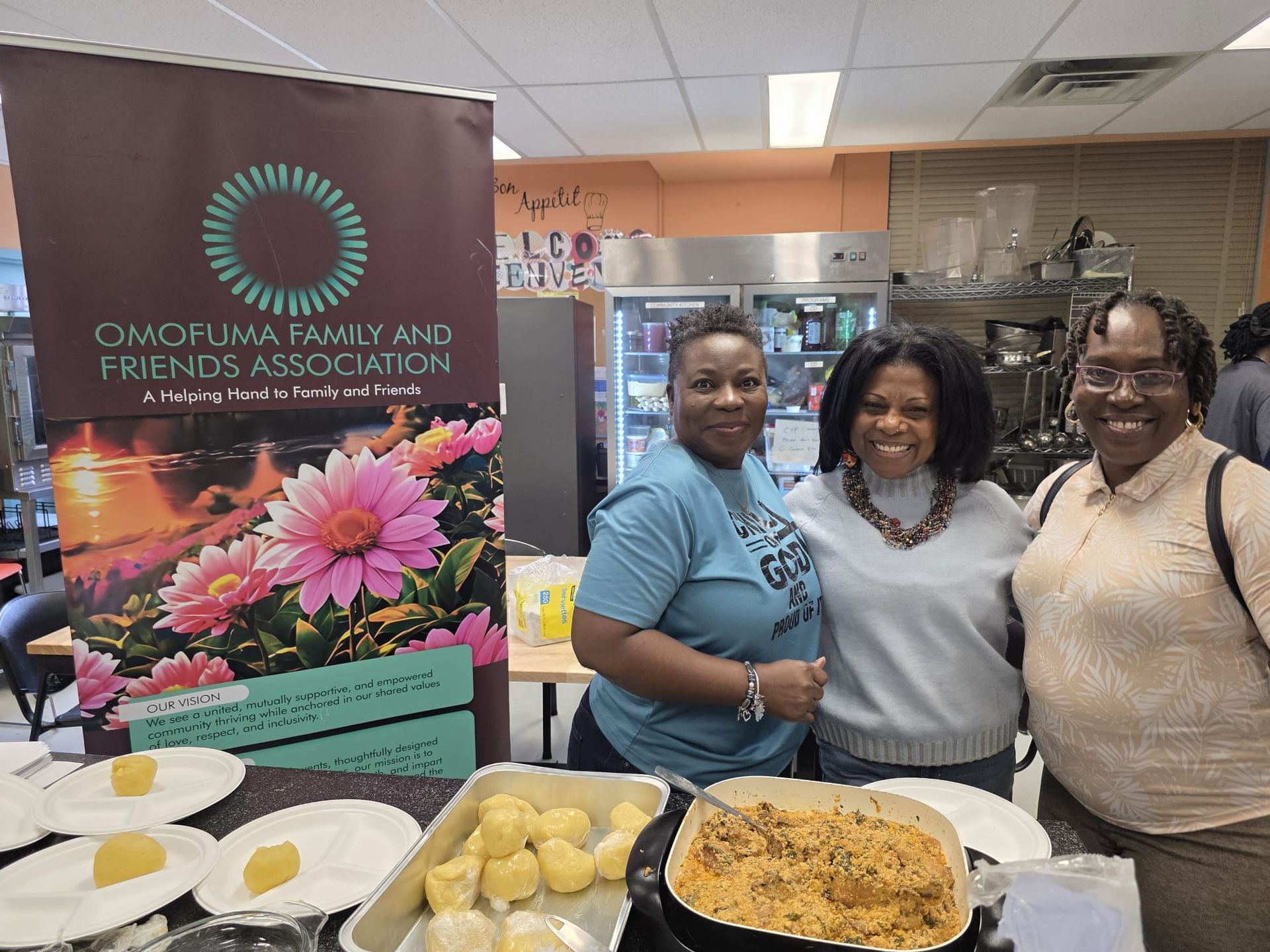 Three people at a food display. Banner reads