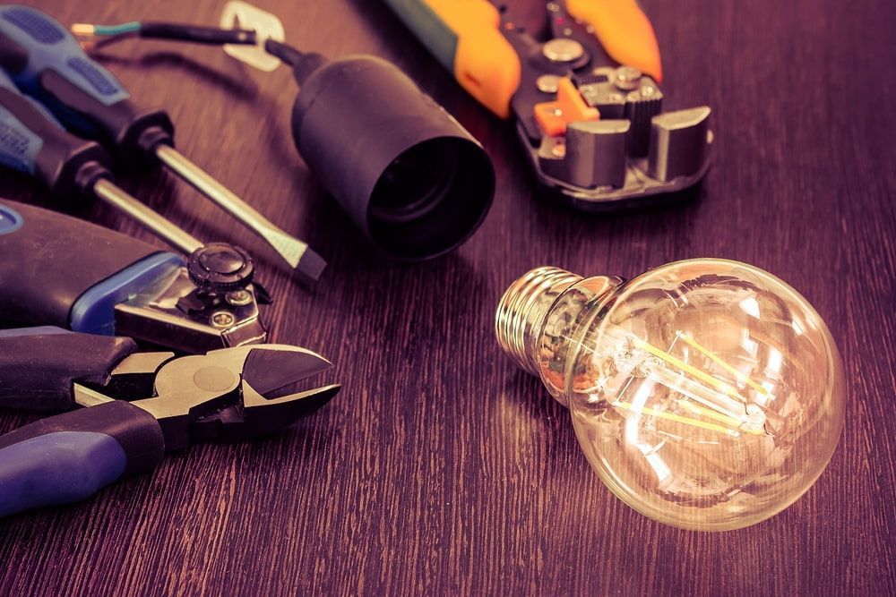 Light Bulb And Other Electrician Tools — Electricians in South Burnett, QLD