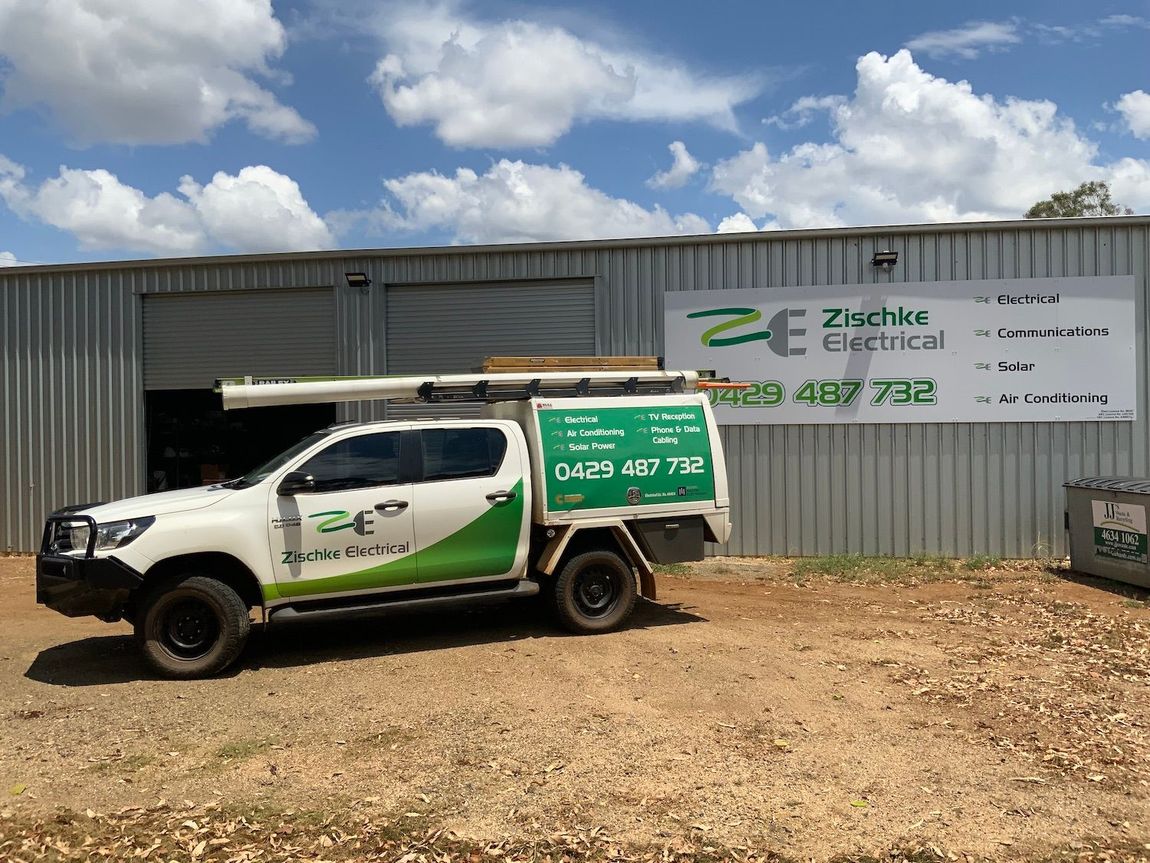 Electrician Holding Tool Box Near Electrical Box — Electricians in South Burnett, QLD