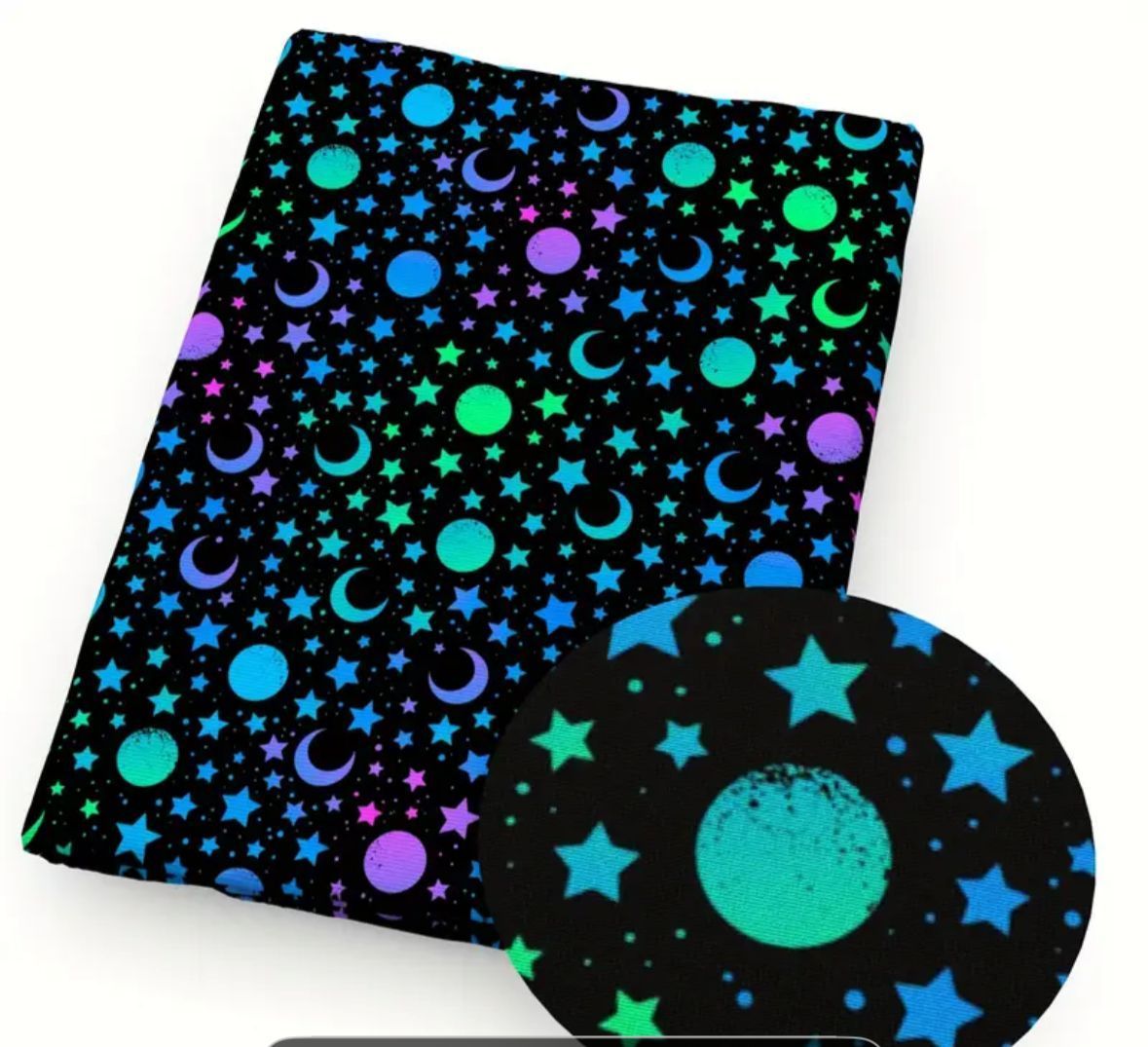 Black fabric patterned with colorful stars, moons, and circles.