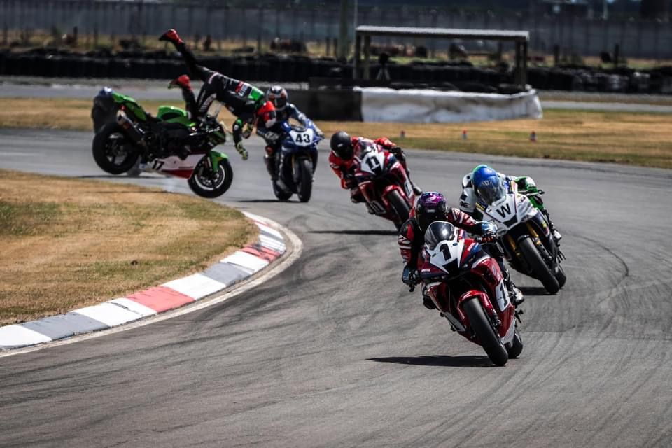 Dale Finch motorbike crash 2024 - Dale in mid air on race track whilst race continues.