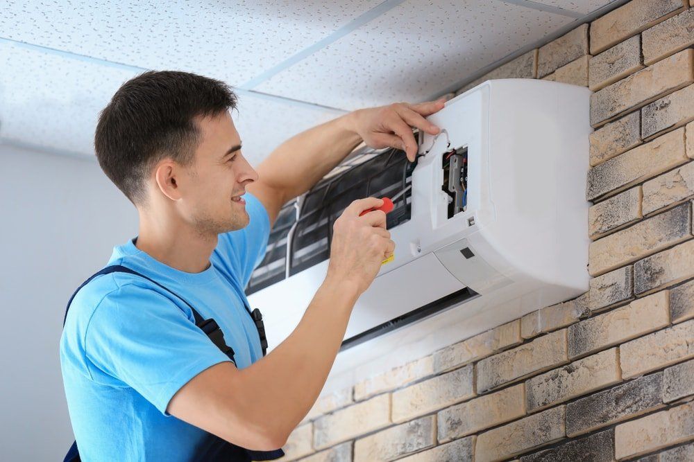 A professional fixing a heating and cooling system