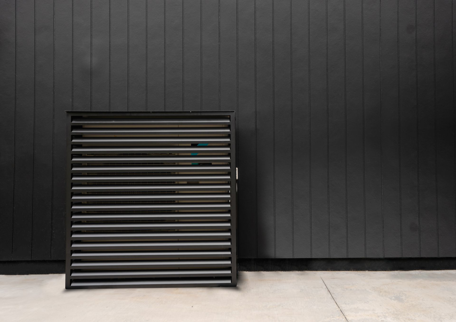 Daikin heat pump outdoor cover against black wall